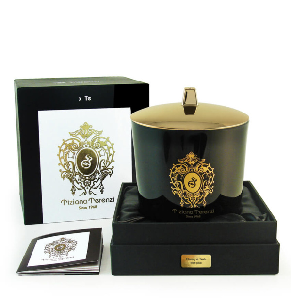 Candela profumata Tiziana Terenzi 'Ebony e Teck' in edizione Black Glass, presentata in un raffinato vaso nero con coperchio dorato. La candela è confezionata in una scatola nera elegante con dettagli dorati, simbolo di lusso e qualità artigianale.